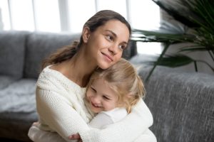 mother hugging he young daughter