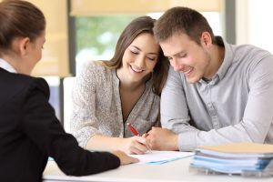couple drafting their prenuptial agreement and smiling