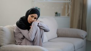 lonely woman sitting on a couch